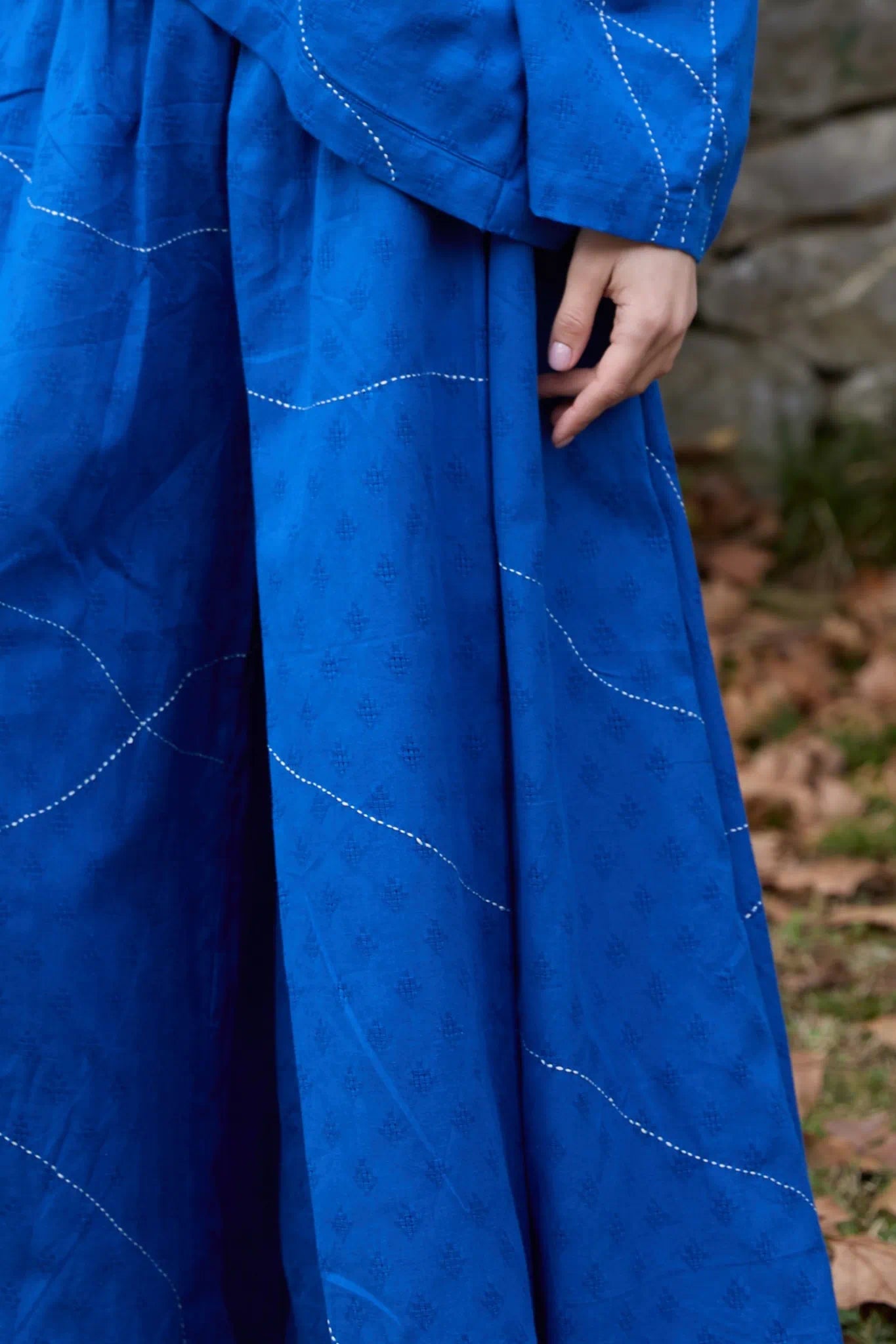 White Canvas Cloud Dahlia Pants in blue handwoven dobby cotton with Kantha stitching, detail view on model