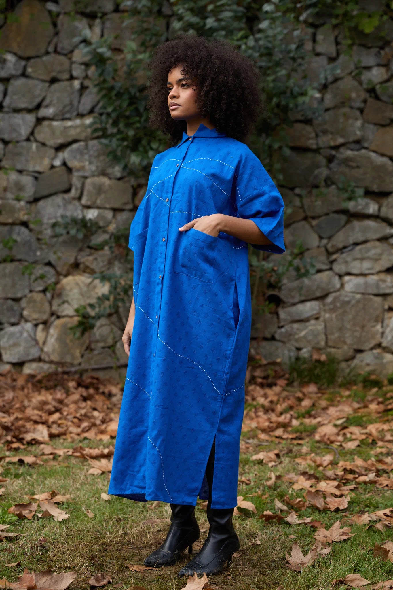 White Canvas Cloud Shine Dress in blue handwoven dobby cotton with Kantha stitching, angled view on model