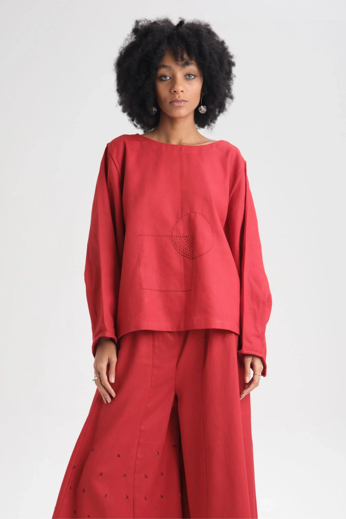 White Canvas Red Calla Top in red organic drill cotton with embroidery, front view on model