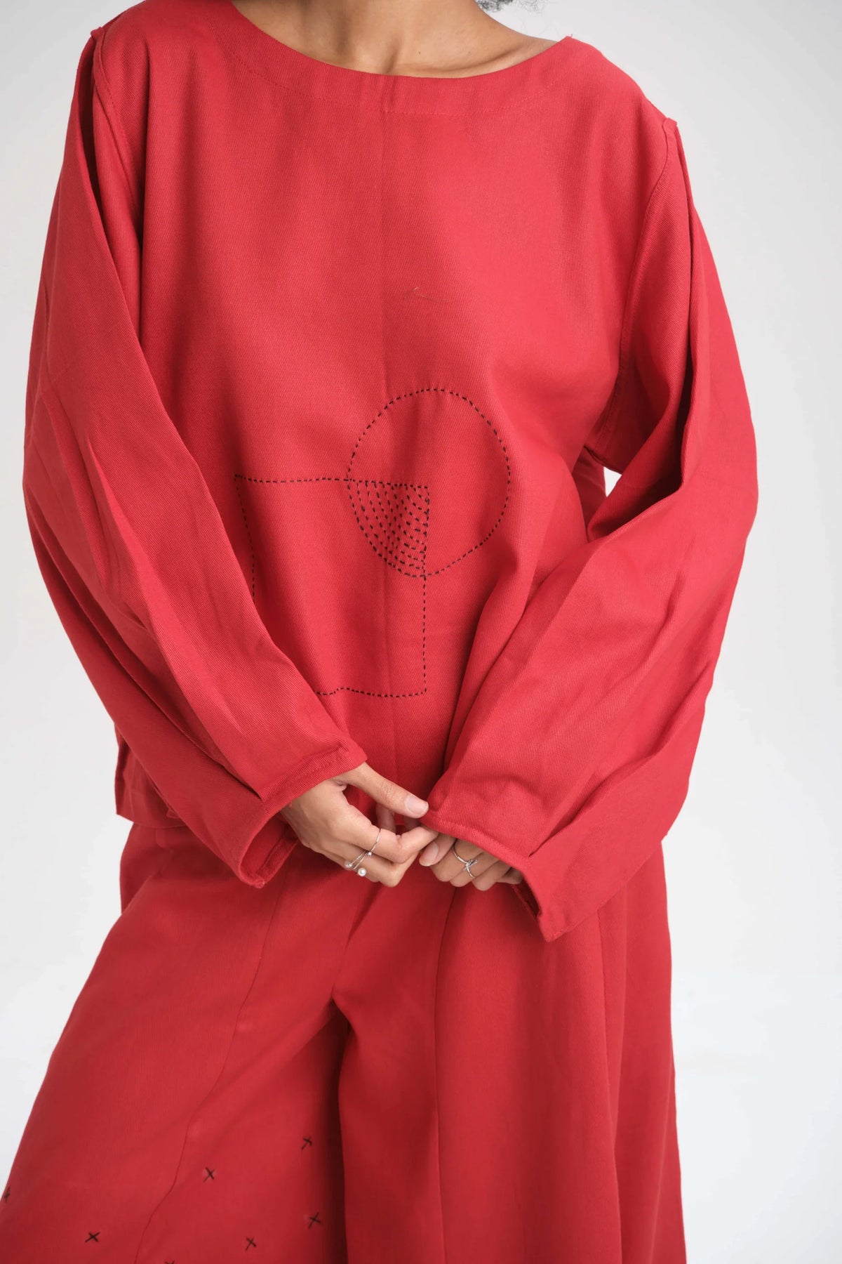 White Canvas Red Calla Top in red organic drill cotton with embroidery, angled view on model