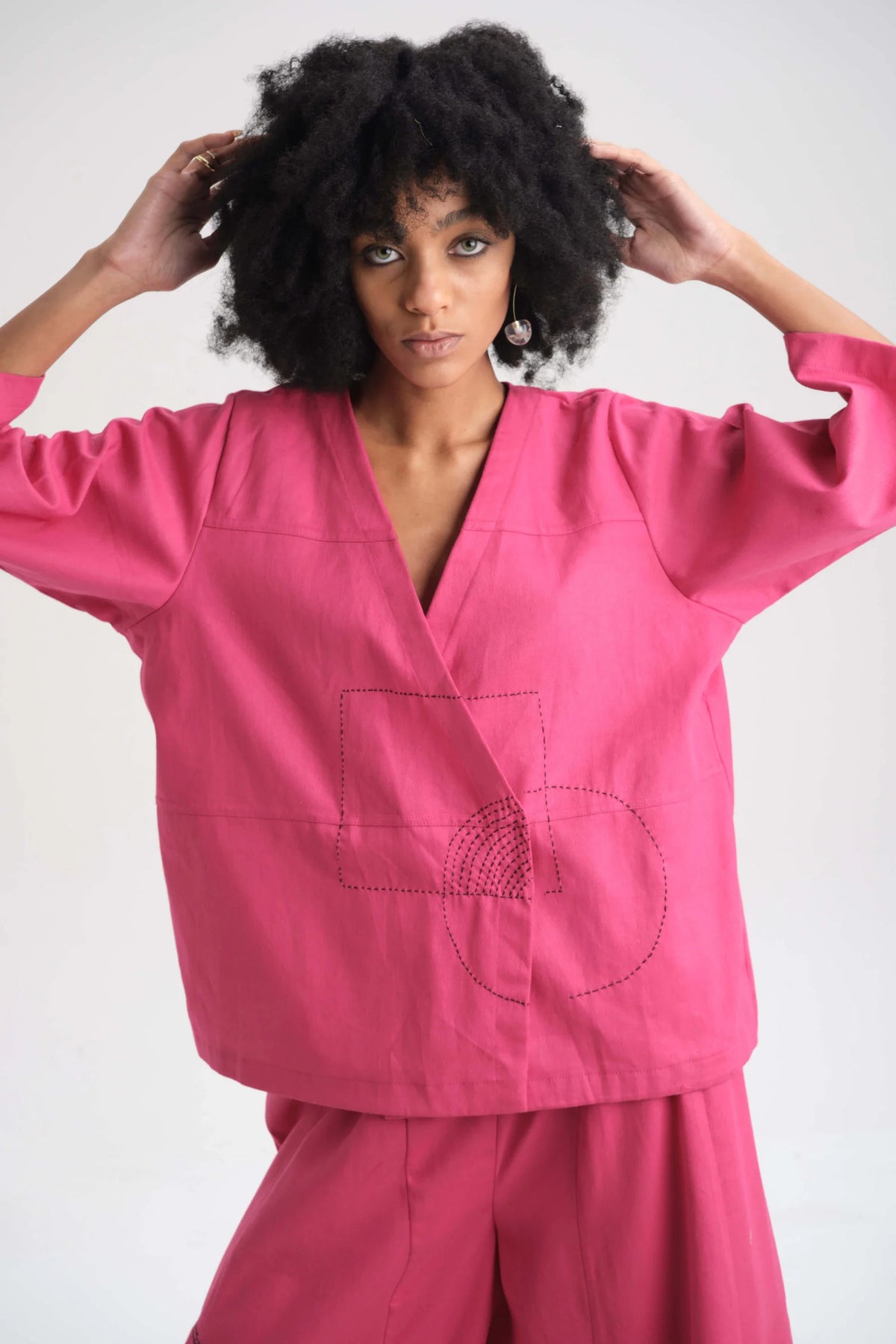 White Canvas Pink Peony Top in pink organic drill cotton with embroidery, angled view on model