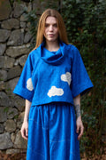 White Canvas Cloud Butter Top in blue handwoven dobby cotton with applique work, front view on model