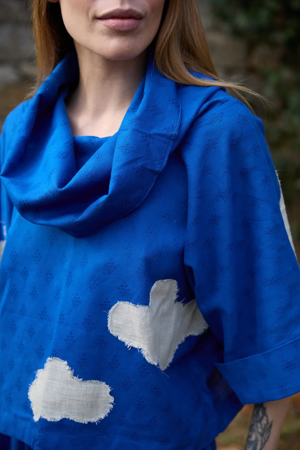 White Canvas Cloud Butter Top in blue handwoven dobby cotton with applique work, detail view on model