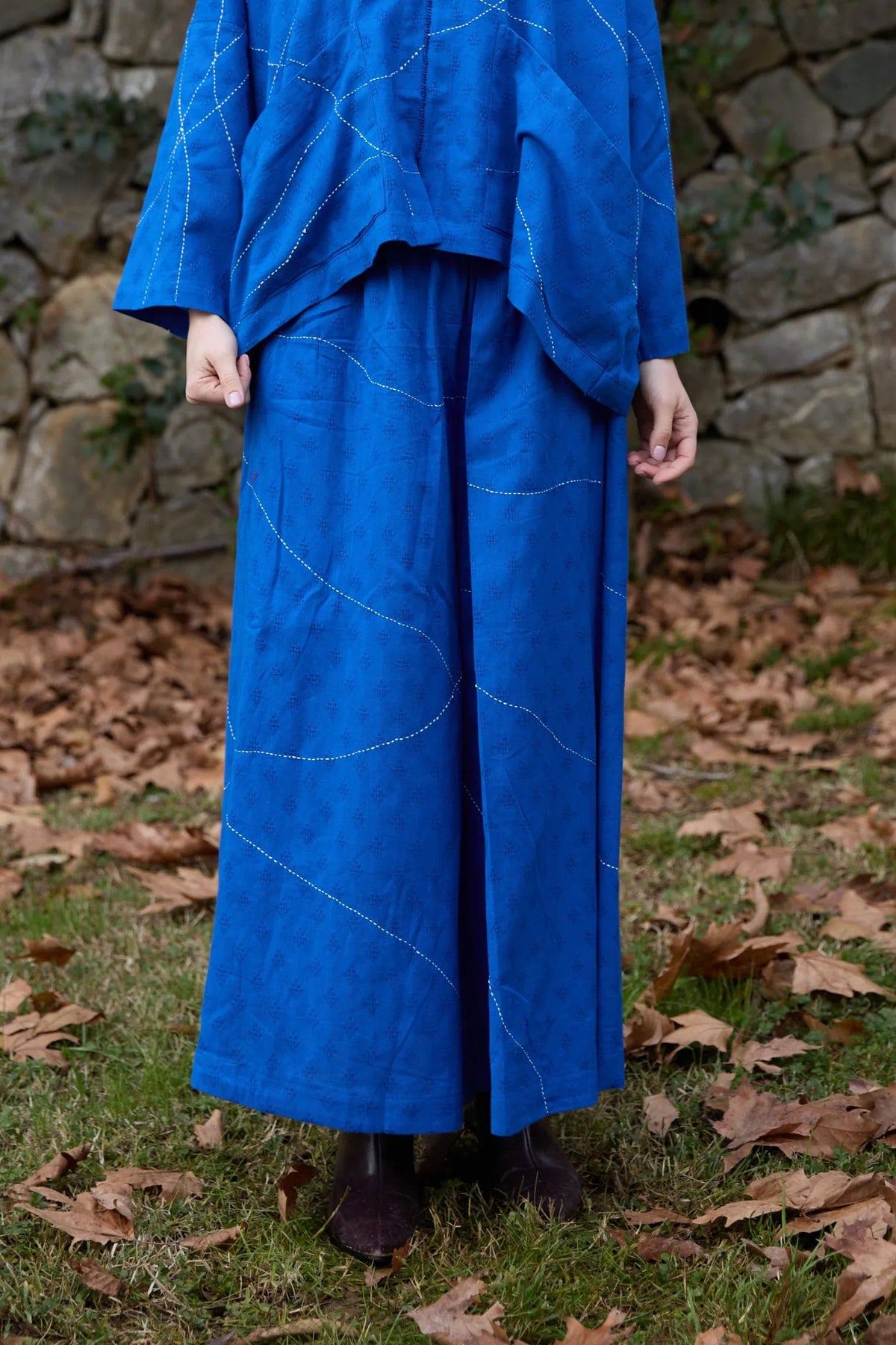 White Canvas Cloud Dahlia Pants in blue handwoven dobby cotton with Kantha stitching, front view on model