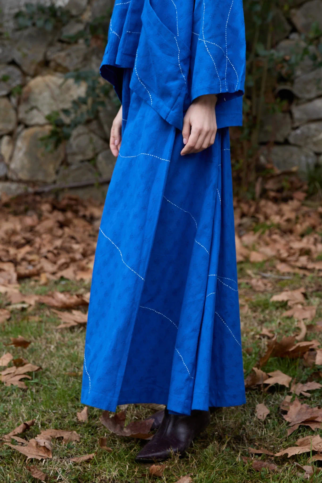 White Canvas Cloud Dahlia Pants in blue handwoven dobby cotton with Kantha stitching, side view on model