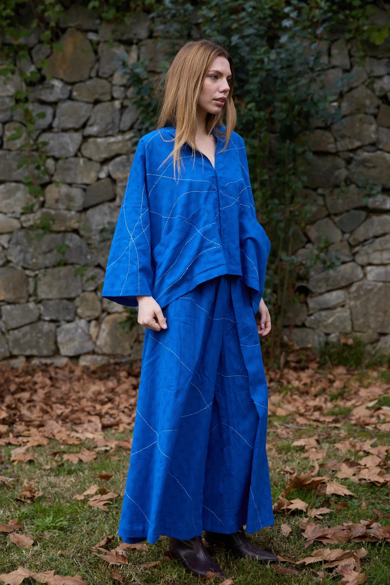 White Canvas Cloud Dahlia Set in blue handwoven dobby cotton with Kantha stitching, angled view on model