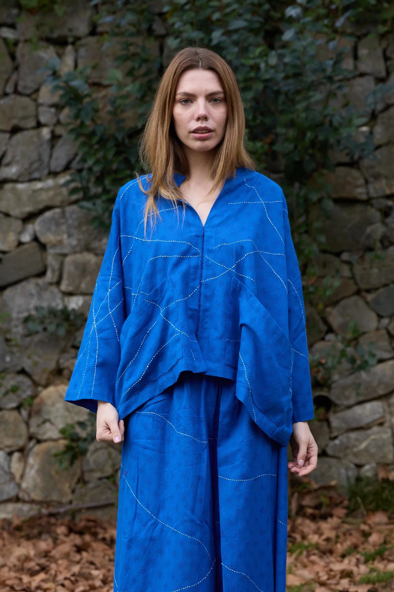 White Canvas Cloud Dahlia Top in blue handwoven dobby cotton with Kantha stitching, front view on model