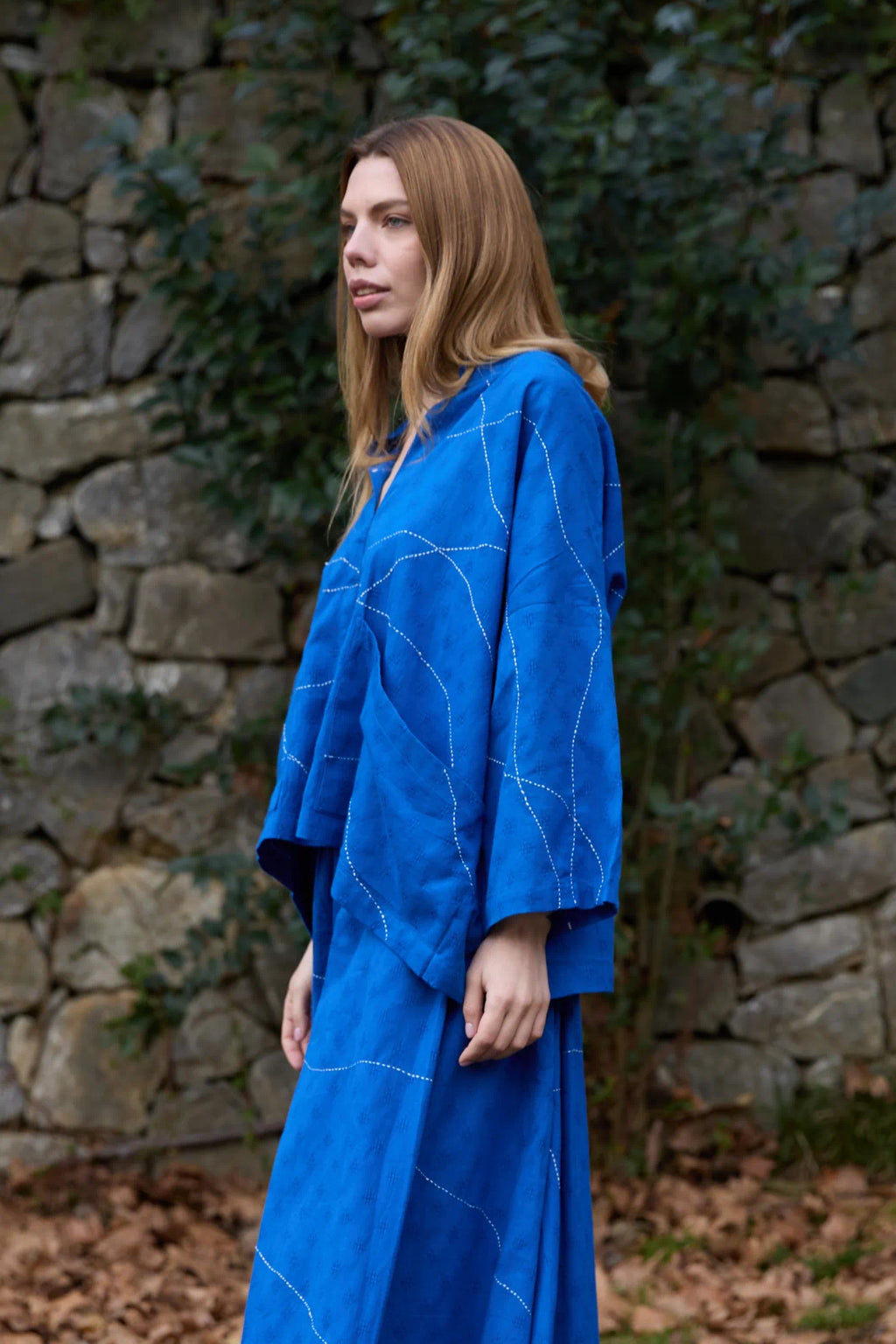 White Canvas Cloud Dahlia Top in blue handwoven dobby cotton with Kantha stitching, side view on model