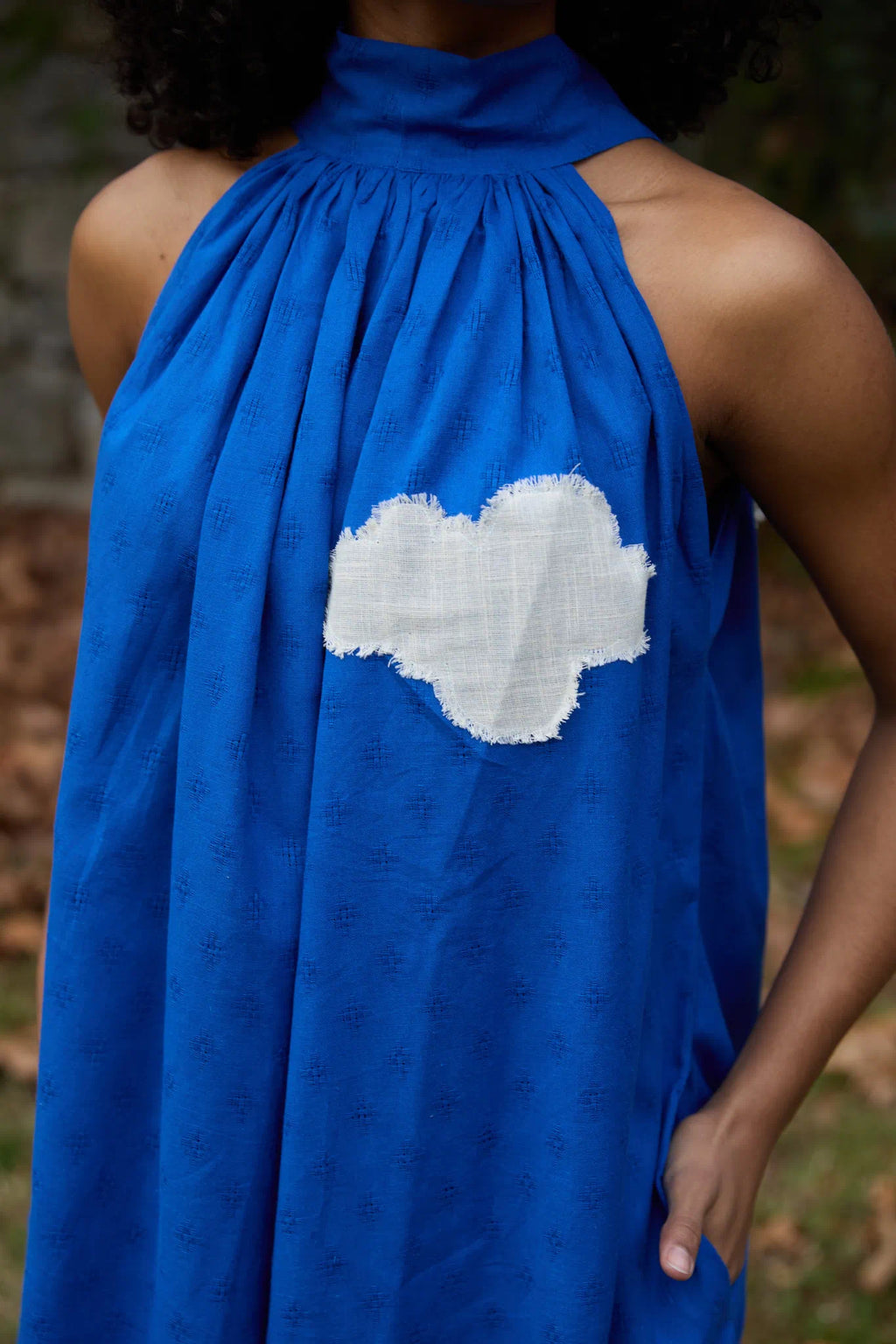 White Canvas Cloud Flintstone Dress in blue handwoven dobby cotton with applique work, detail view on model