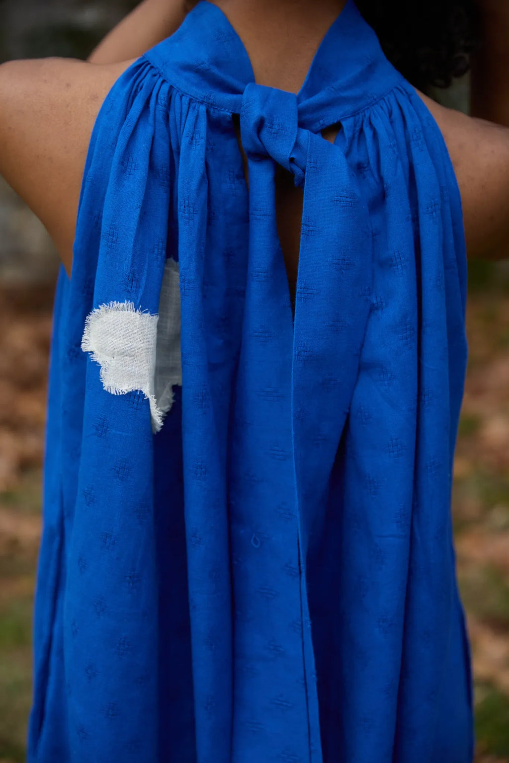 White Canvas Cloud Flintstone Dress in blue handwoven dobby cotton with applique work, full-length styled view