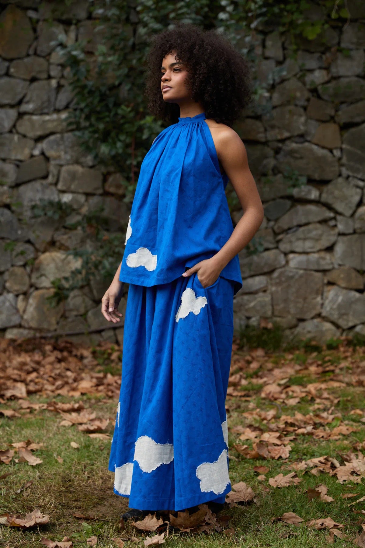 White Canvas Cloud Flintstone Set in blue handwoven dobby cotton with applique work, angled view on model