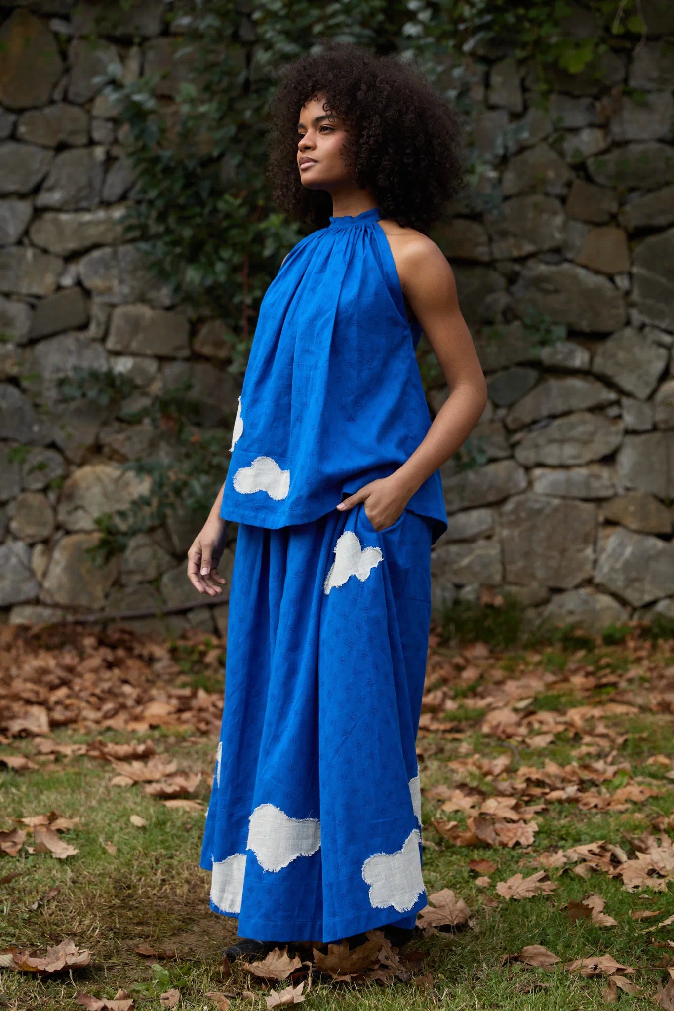 White Canvas Cloud Flintstone Set in blue handwoven dobby cotton with applique work, angled view on model