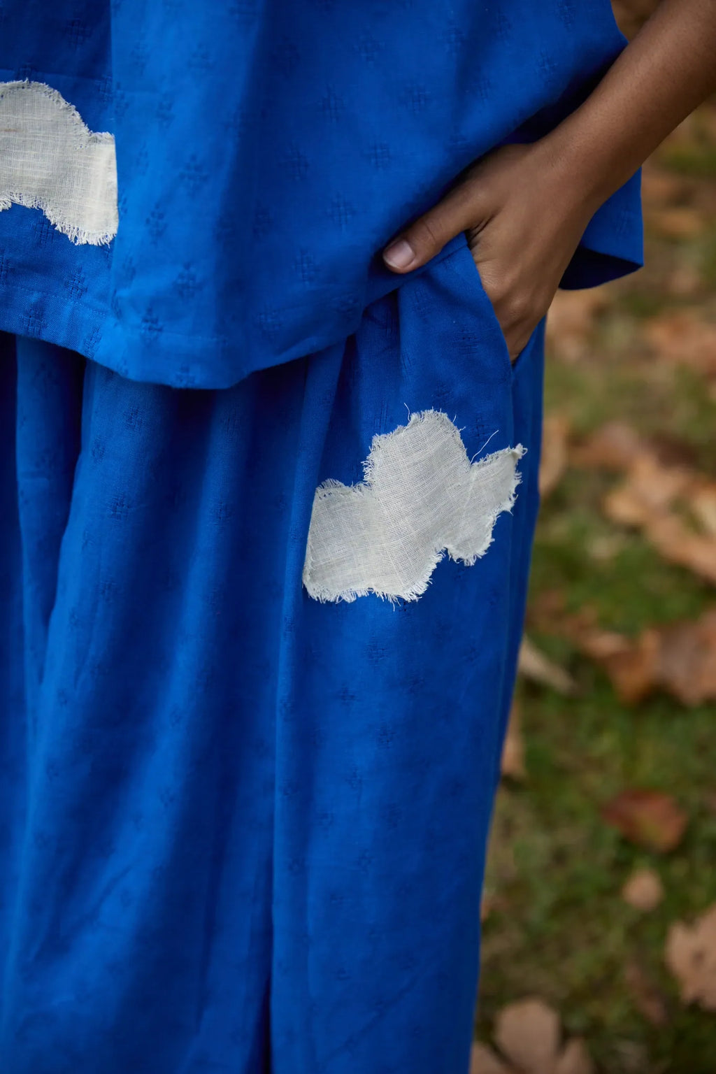 White Canvas Cloud Flintstone Set in blue handwoven dobby cotton with applique work, detail view on model