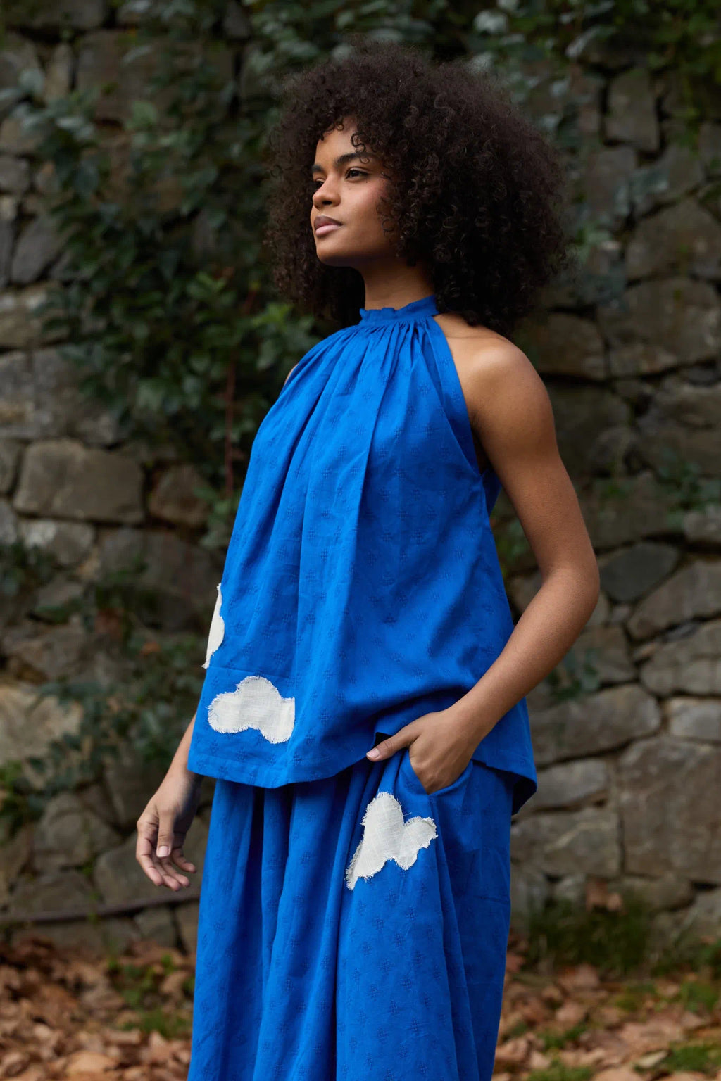 White Canvas Cloud Flintstone Top in blue handwoven dobby cotton with applique work, angled view on model