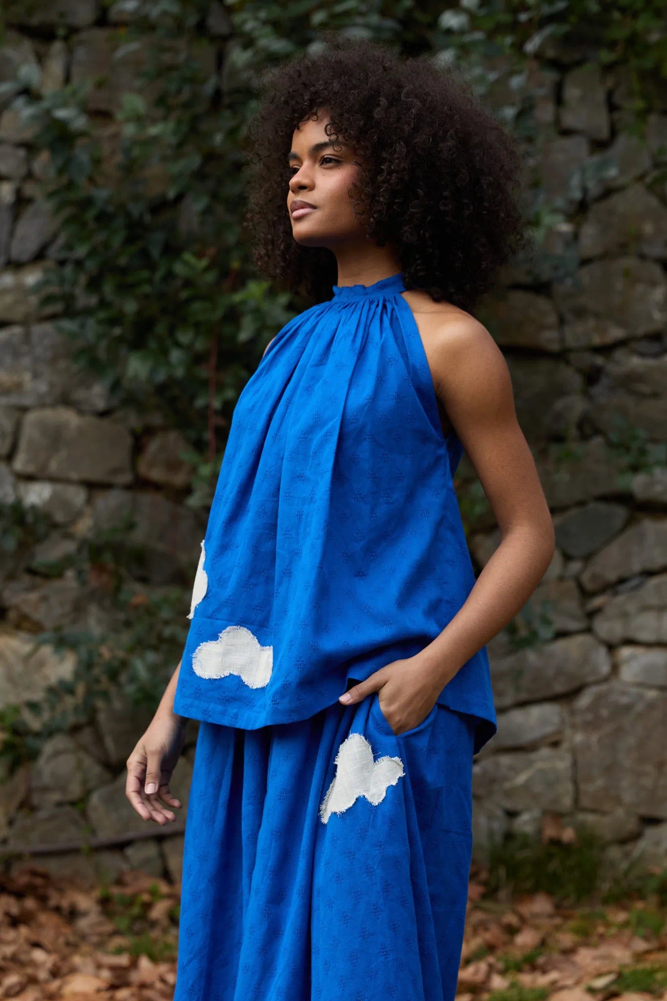 White Canvas Cloud Flintstone Top in blue handwoven dobby cotton with applique work, angled view on model