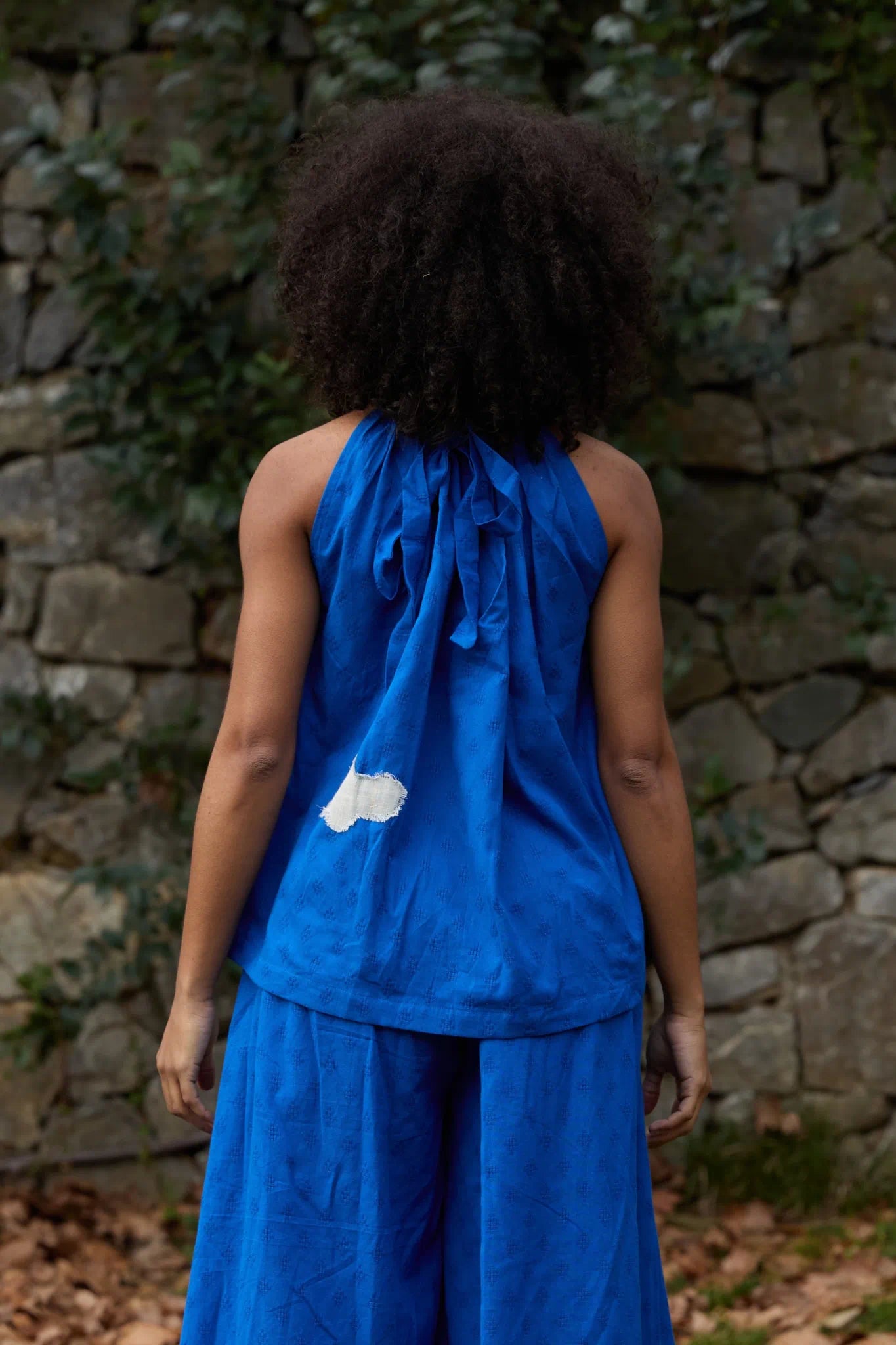 White Canvas Cloud Flintstone Top in blue handwoven dobby cotton with applique work, back view on model