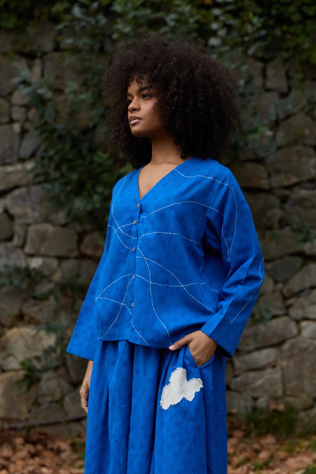 White Canvas Cloud Glimpse Top in blue handwoven dobby cotton with Kantha stitching, angled view on model