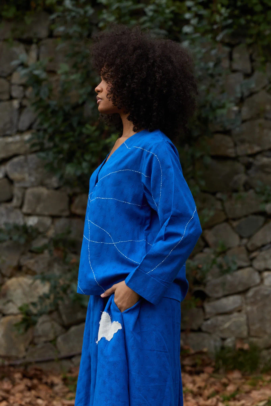 White Canvas Cloud Glimpse Top in blue handwoven dobby cotton with Kantha stitching, side view on model