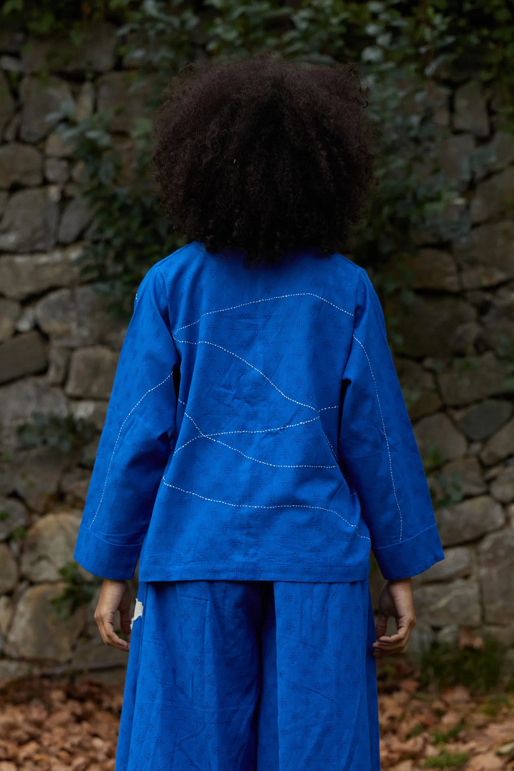 White Canvas Cloud Glimpse Top in blue handwoven dobby cotton with Kantha stitching, back view on model