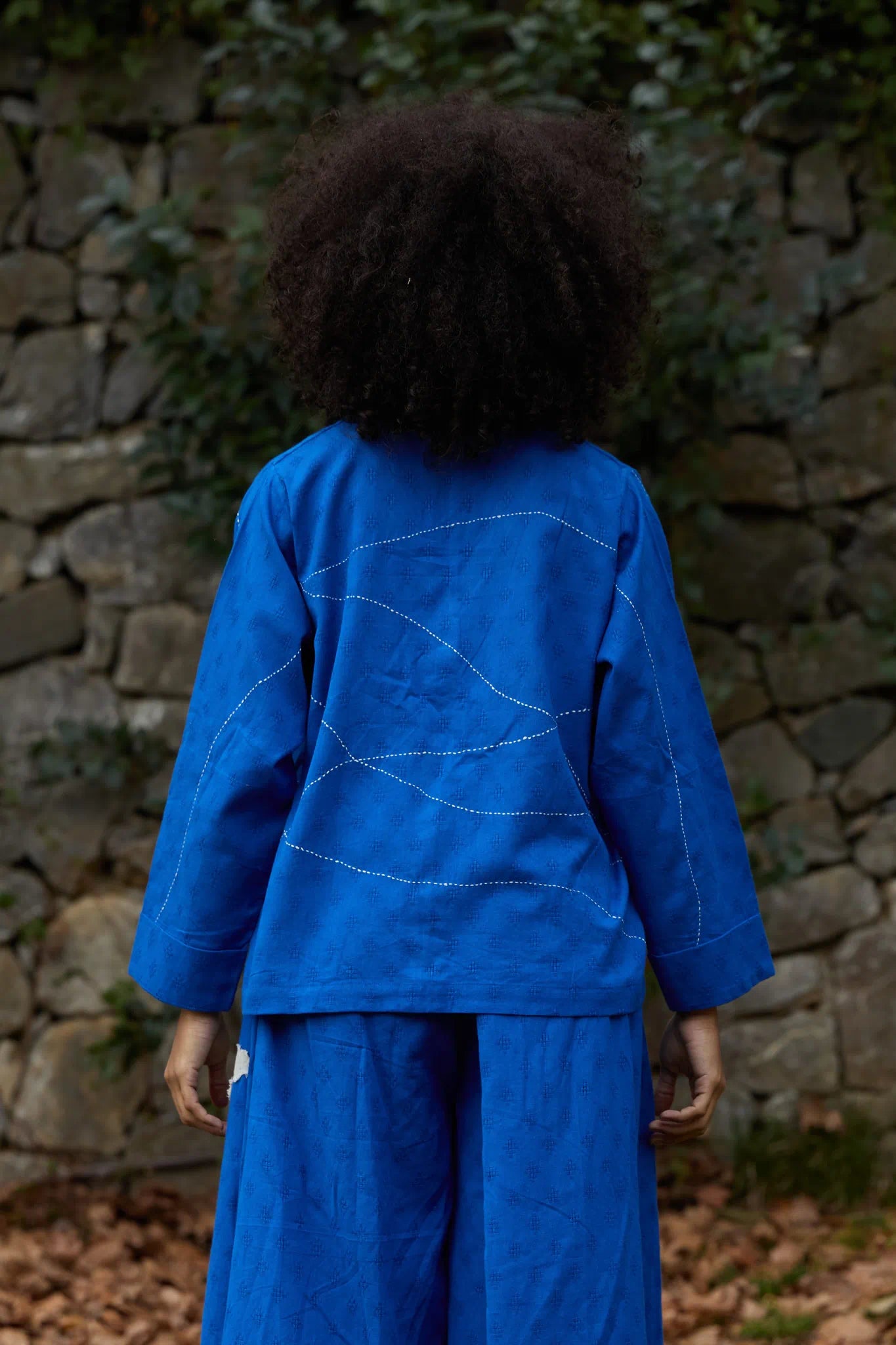 White Canvas Cloud Glimpse Top in blue handwoven dobby cotton with Kantha stitching, back view on model