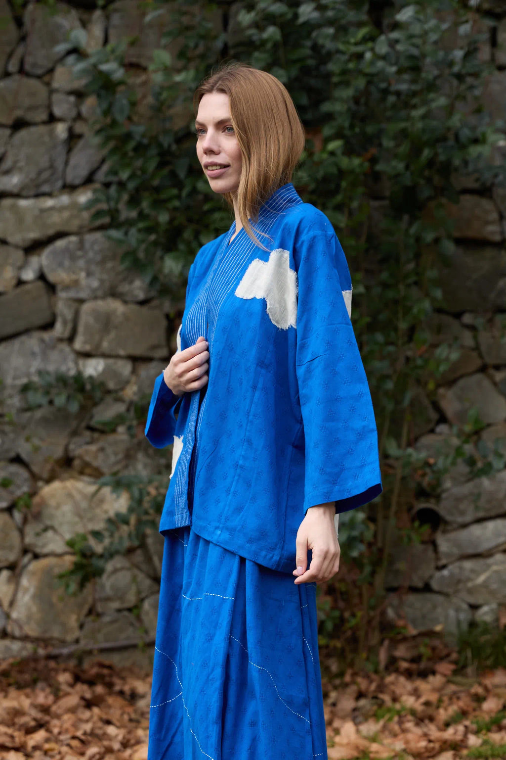 White Canvas Cloud Indore Jacket in blue handwoven dobby cotton with applique work, angled view on model