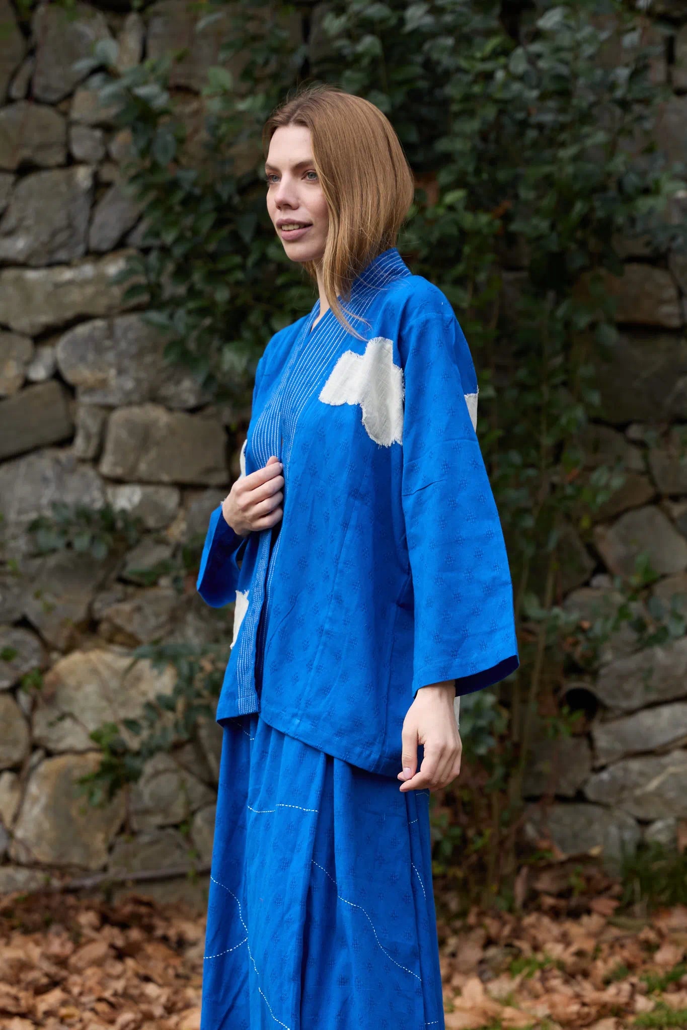 White Canvas Cloud Indore Jacket in blue handwoven dobby cotton with applique work, angled view on model