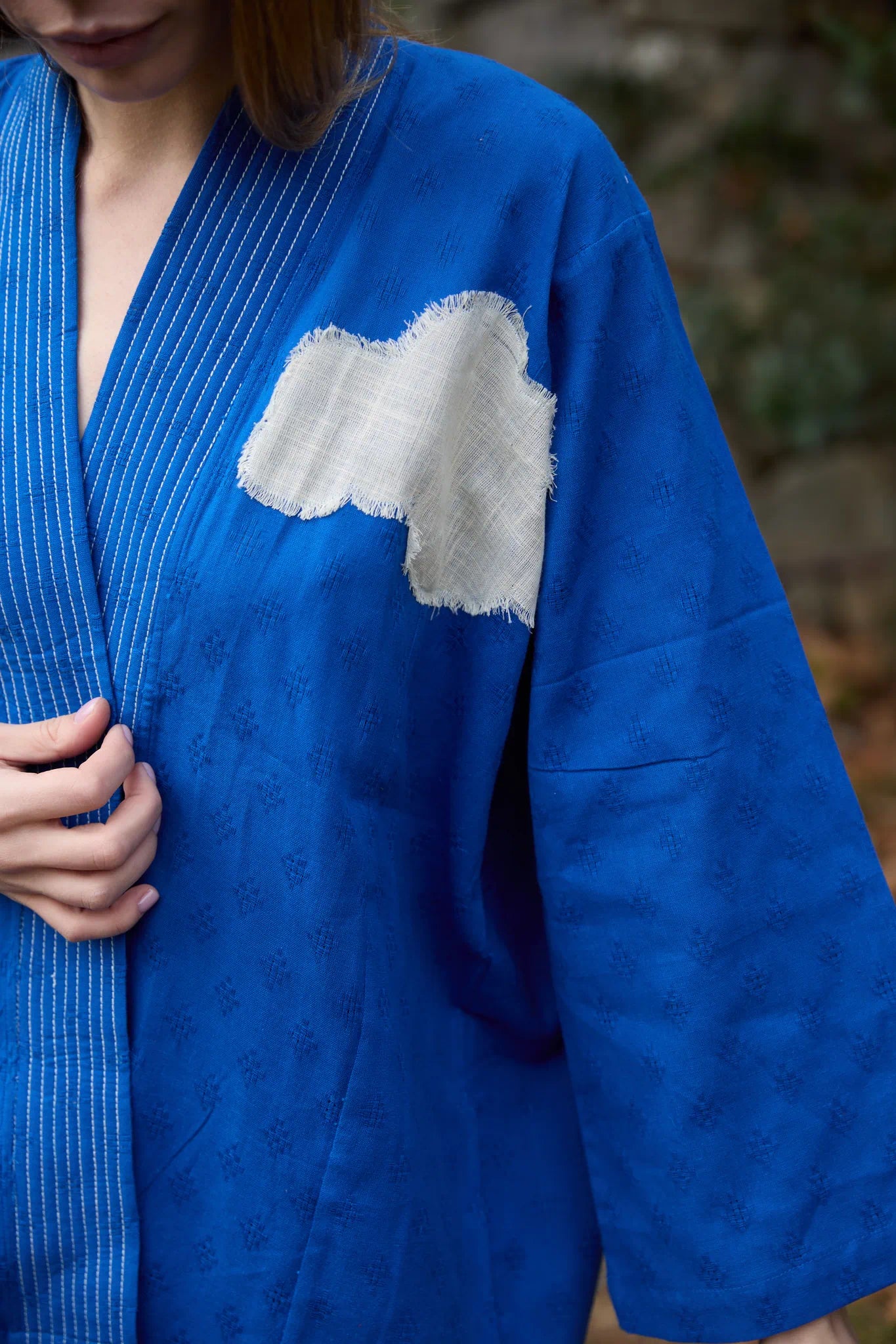 White Canvas Cloud Indore Jacket in blue handwoven dobby cotton with applique work, back view on model