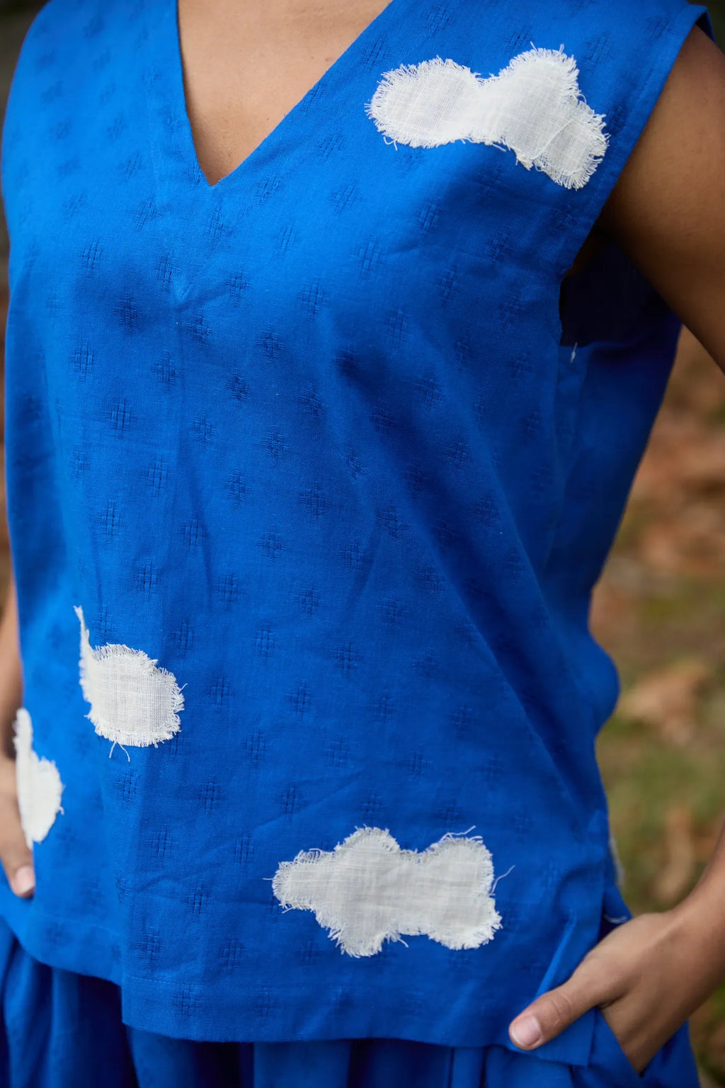 White Canvas Cloud Jerry Set in blue handwoven dobby cotton with applique work, detail view on model