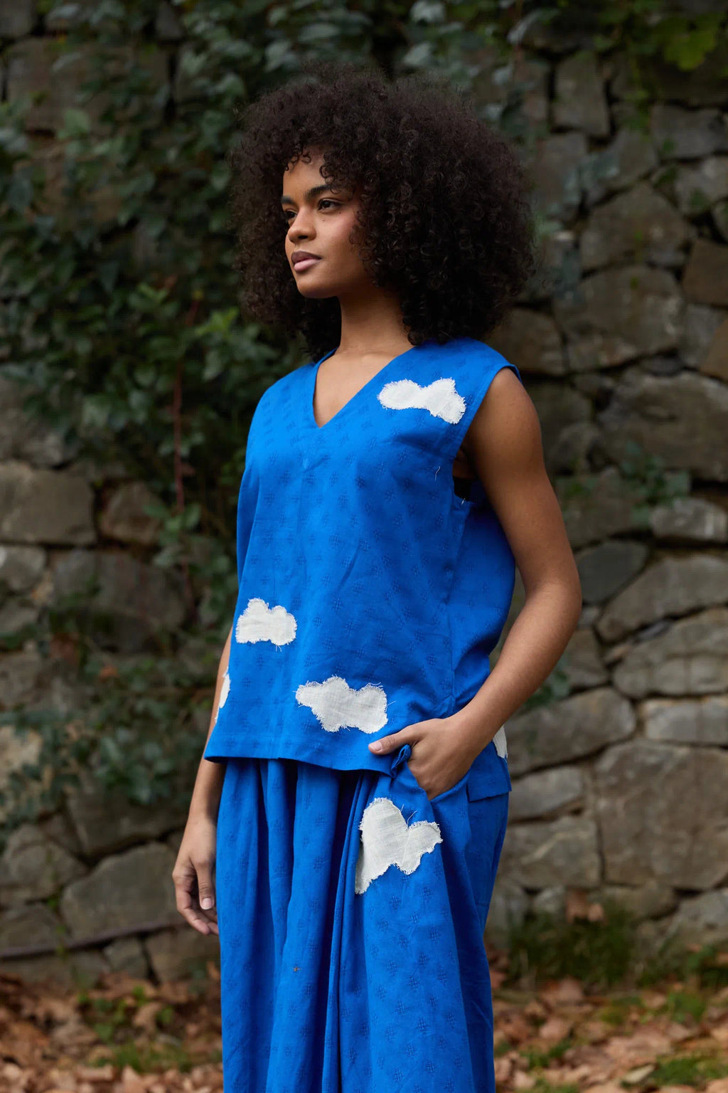 White Canvas Cloud Jerry Top in blue handwoven dobby cotton with applique work, angled view on model