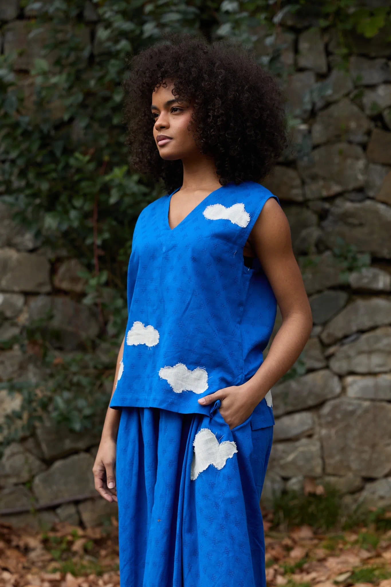 White Canvas Cloud Jerry Top in blue handwoven dobby cotton with applique work, angled view on model