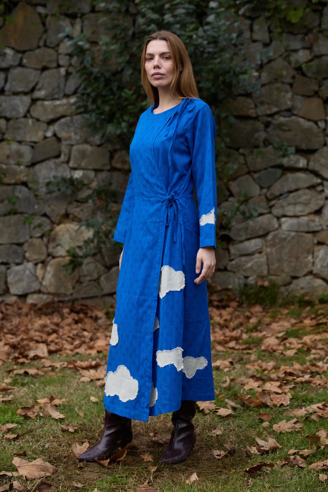White Canvas Cloud Metis Dress in blue handwoven dobby cotton with applique work, angled view on model