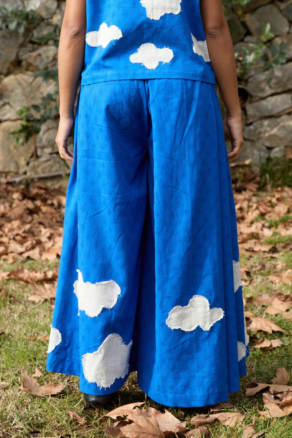 White Canvas Cloud Marti Pants in blue handwoven dobby cotton with applique work, side view on model