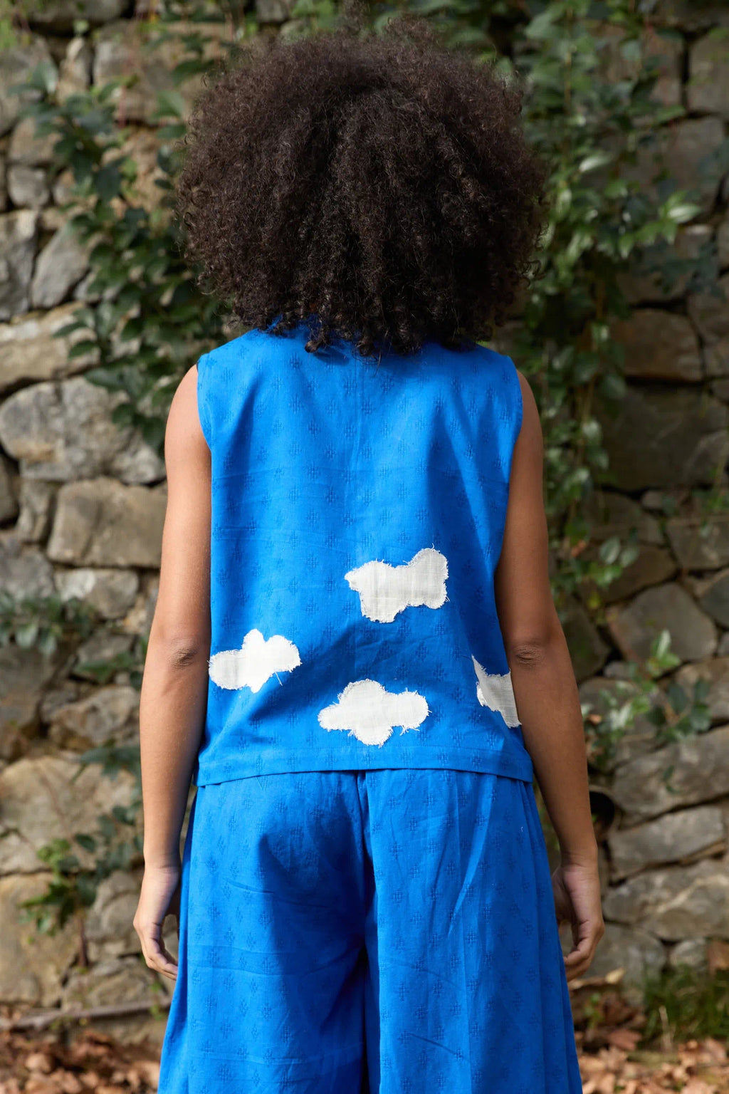 White Canvas Cloud Marti Vest in blue handwoven dobby cotton with applique work, side view on model
