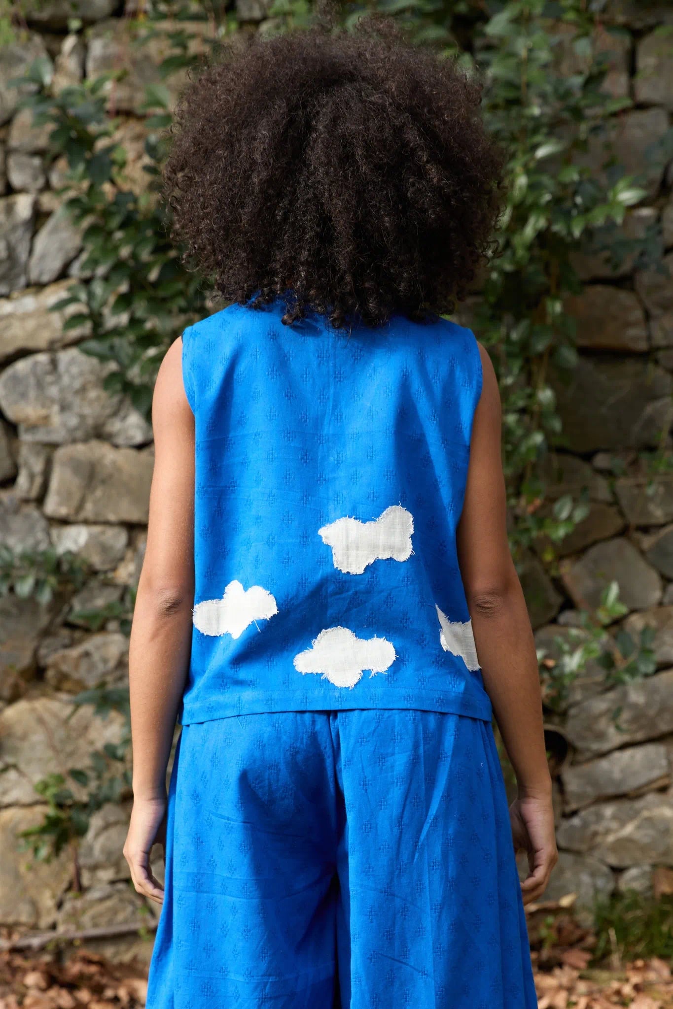 White Canvas Cloud Marti Vest in blue handwoven dobby cotton with applique work, side view on model