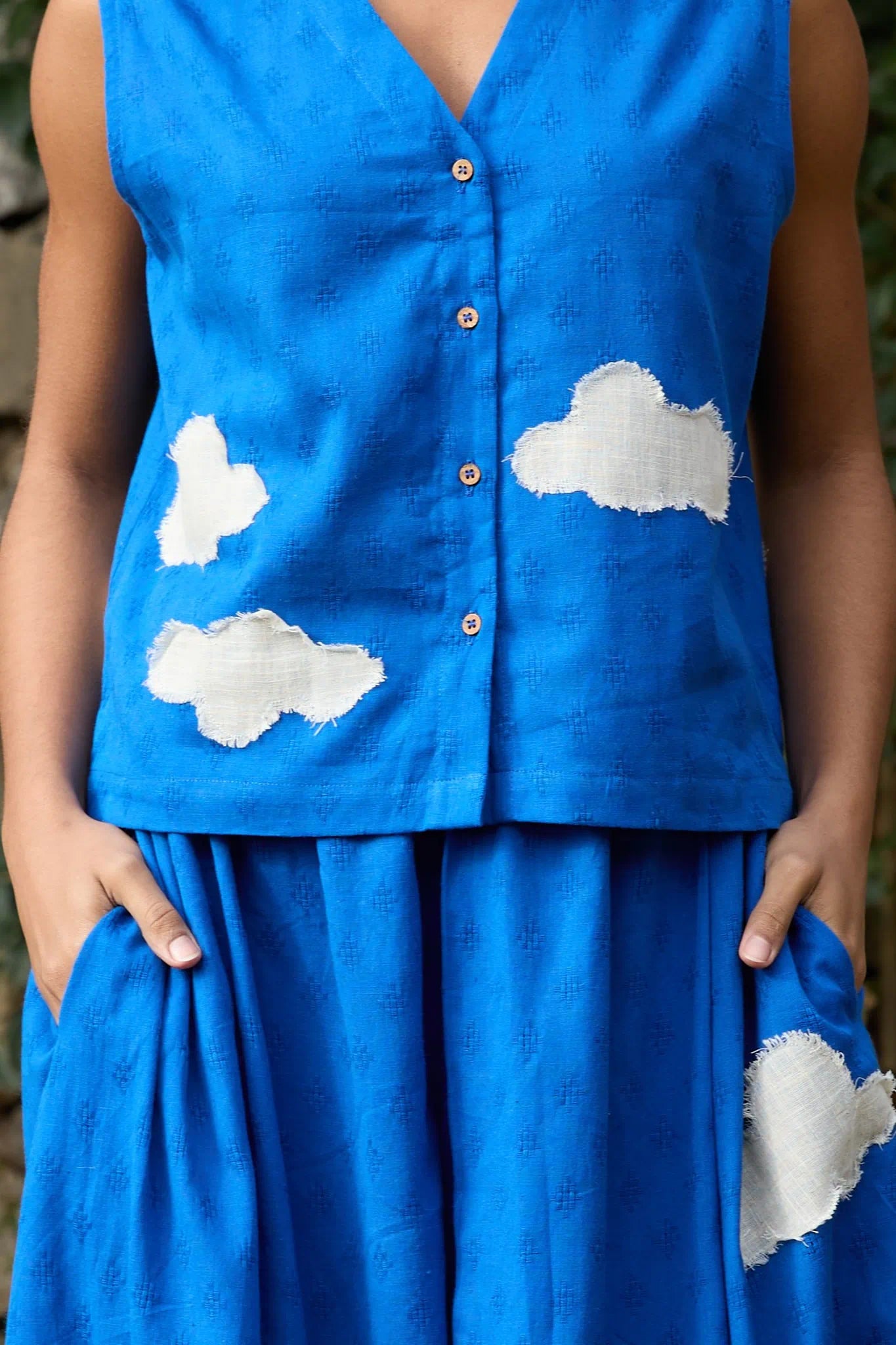 White Canvas Cloud Marti Vest in blue handwoven dobby cotton with applique work, detail view on model