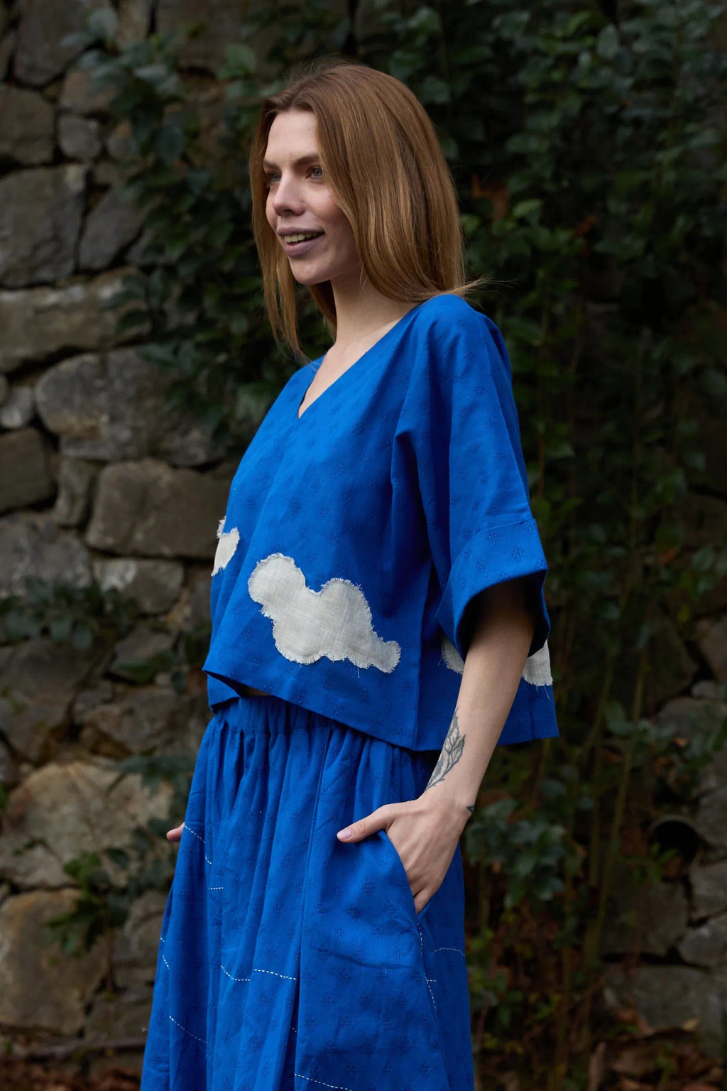 White Canvas Cloud Nikki Top in blue handwoven dobby cotton with applique work, angled view on model