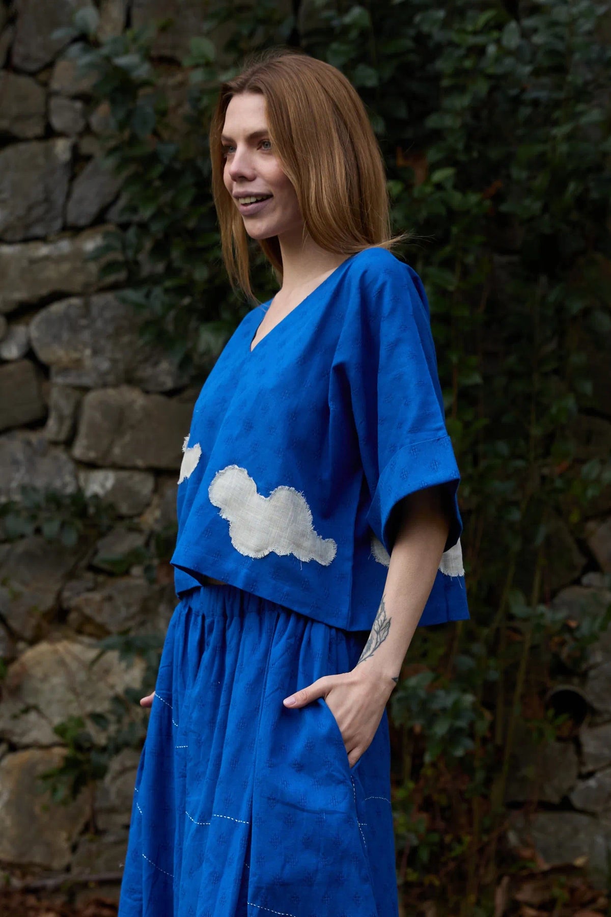 White Canvas Cloud Nikki Top in blue handwoven dobby cotton with applique work, angled view on model