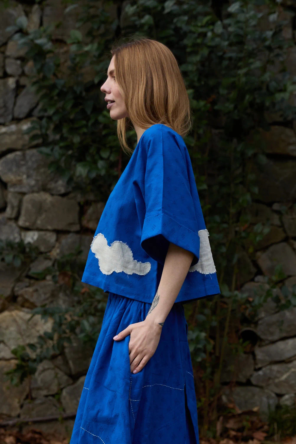 White Canvas Cloud Nikki Top in blue handwoven dobby cotton with applique work, side view on model