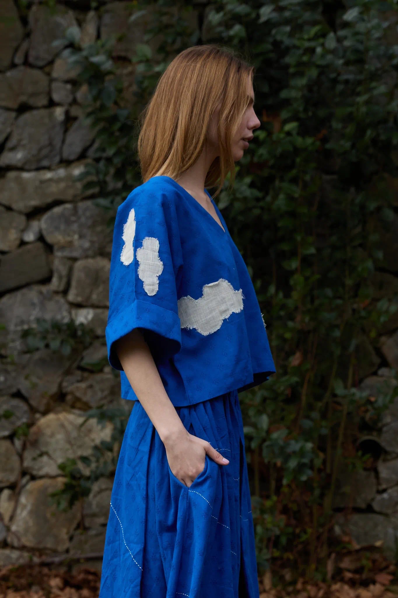 White Canvas Cloud Nikki Top in blue handwoven dobby cotton with applique work, detail view on model