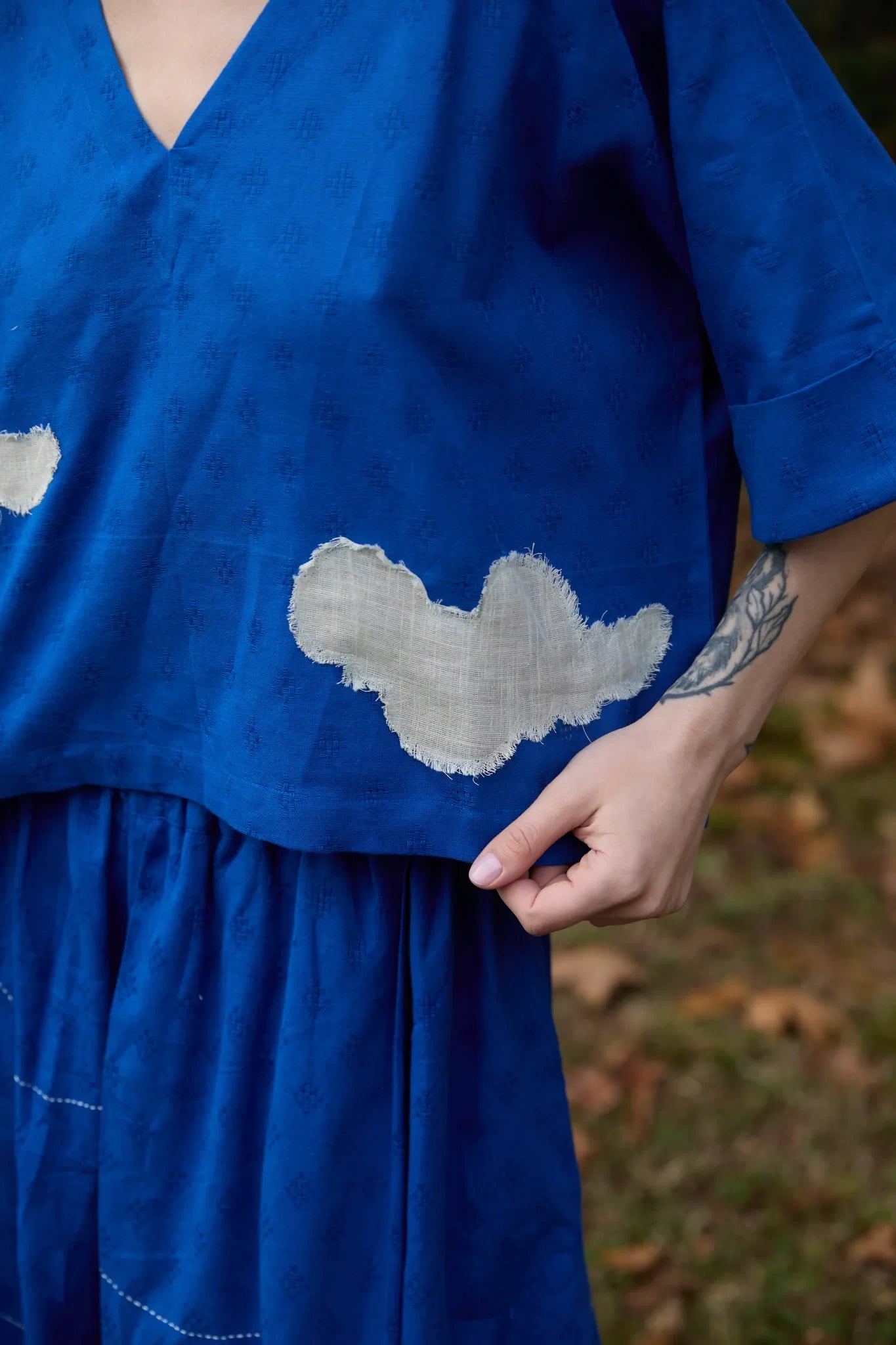White Canvas Cloud Nikki Top in blue handwoven dobby cotton with applique work, full-length styled view