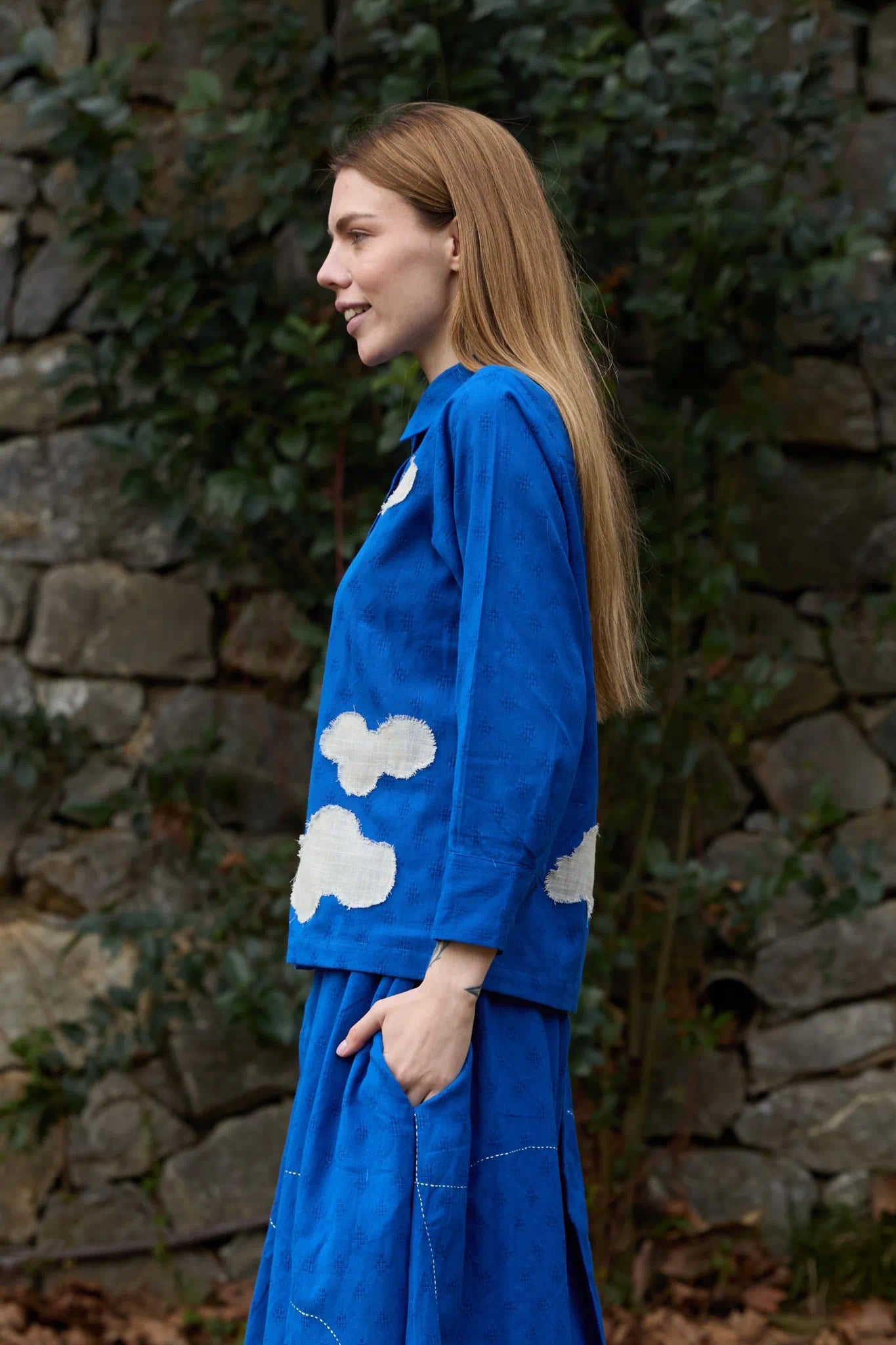 White Canvas Cloud Only Shirt in blue handwoven dobby cotton with applique work and Kantha stitching, side view on model