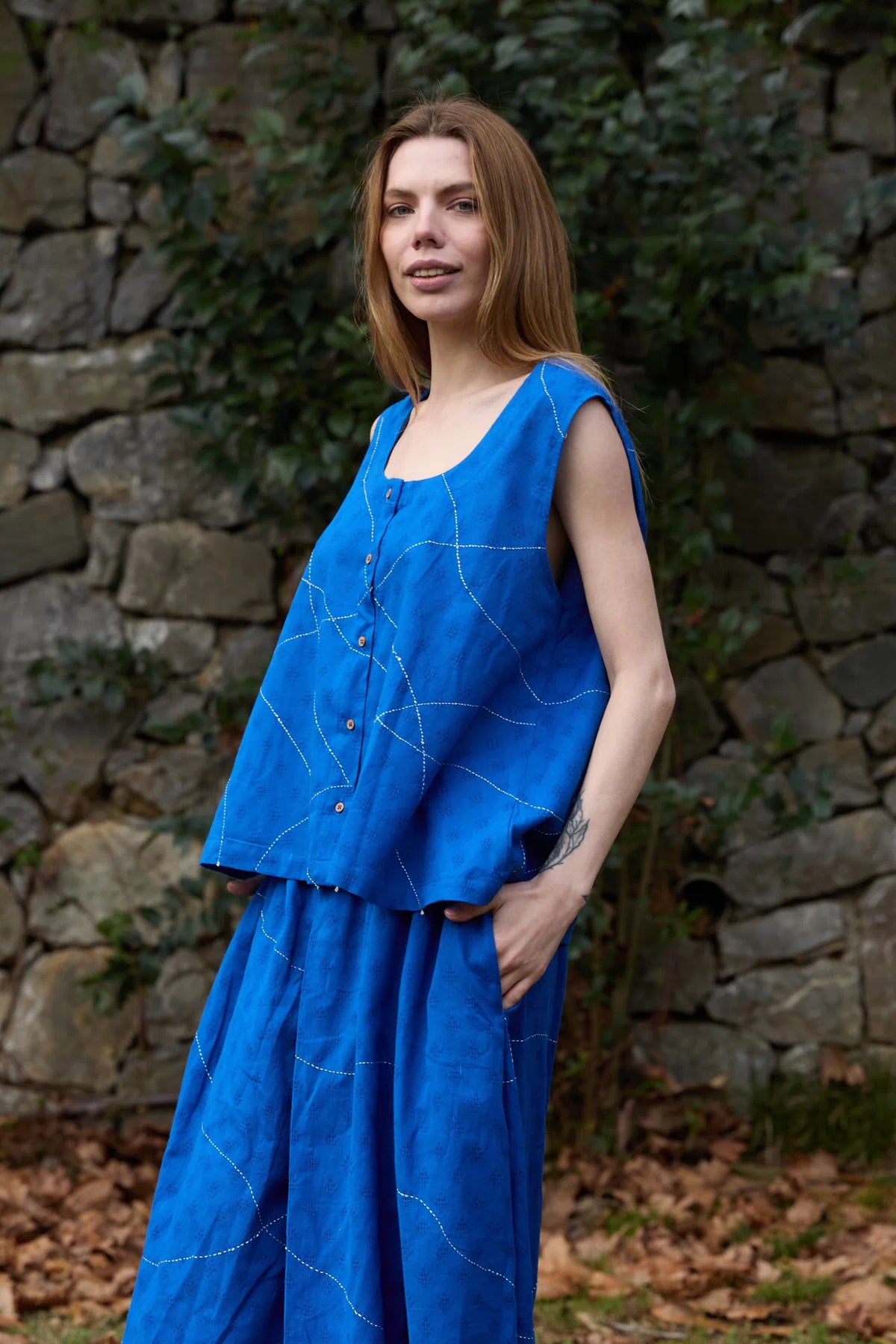 White Canvas Cloud Surreal Top in blue handwoven dobby cotton with Kantha stitching, angled view on model