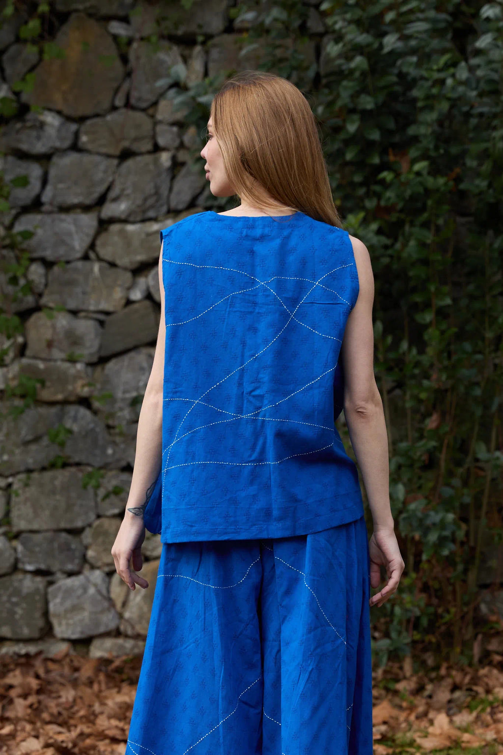 White Canvas Cloud Surreal Top in blue handwoven dobby cotton with Kantha stitching, back view on model