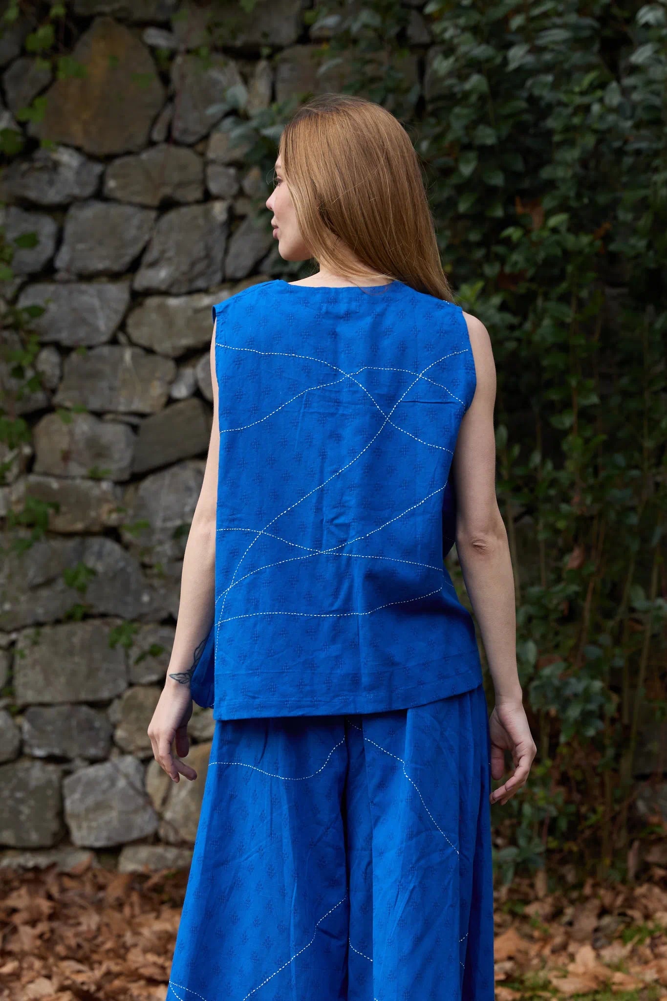 White Canvas Cloud Surreal Top in blue handwoven dobby cotton with Kantha stitching, back view on model