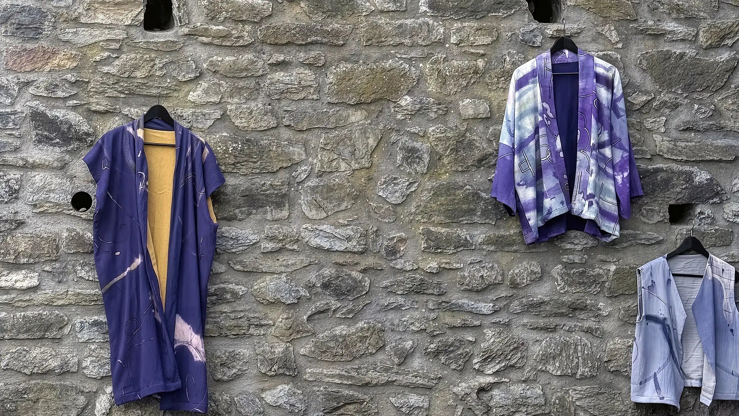 Three colorful tie-dye and washed hand-made garments 