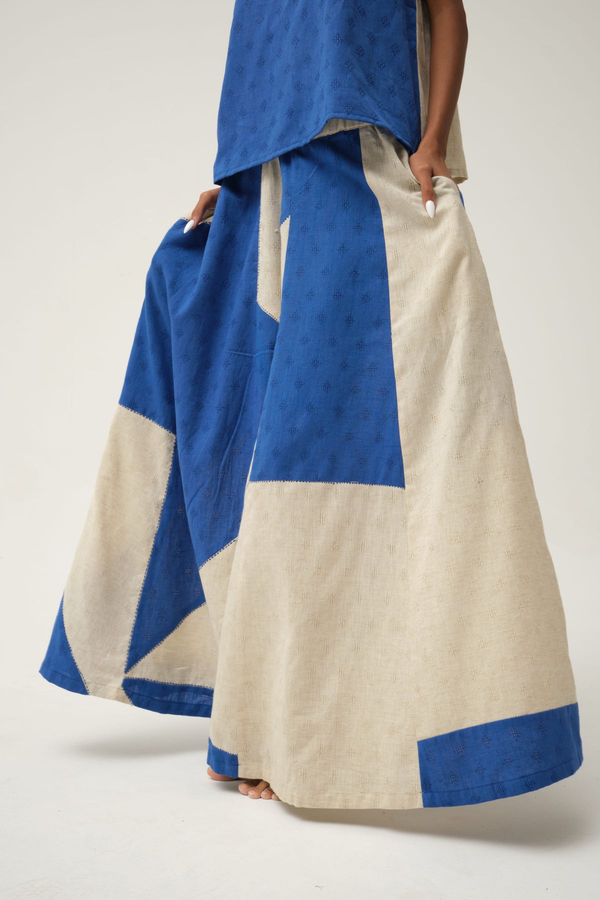 White Canvas Blue Bunny Pants in blue handwoven dobby cotton with handwoven texture, angled view on model