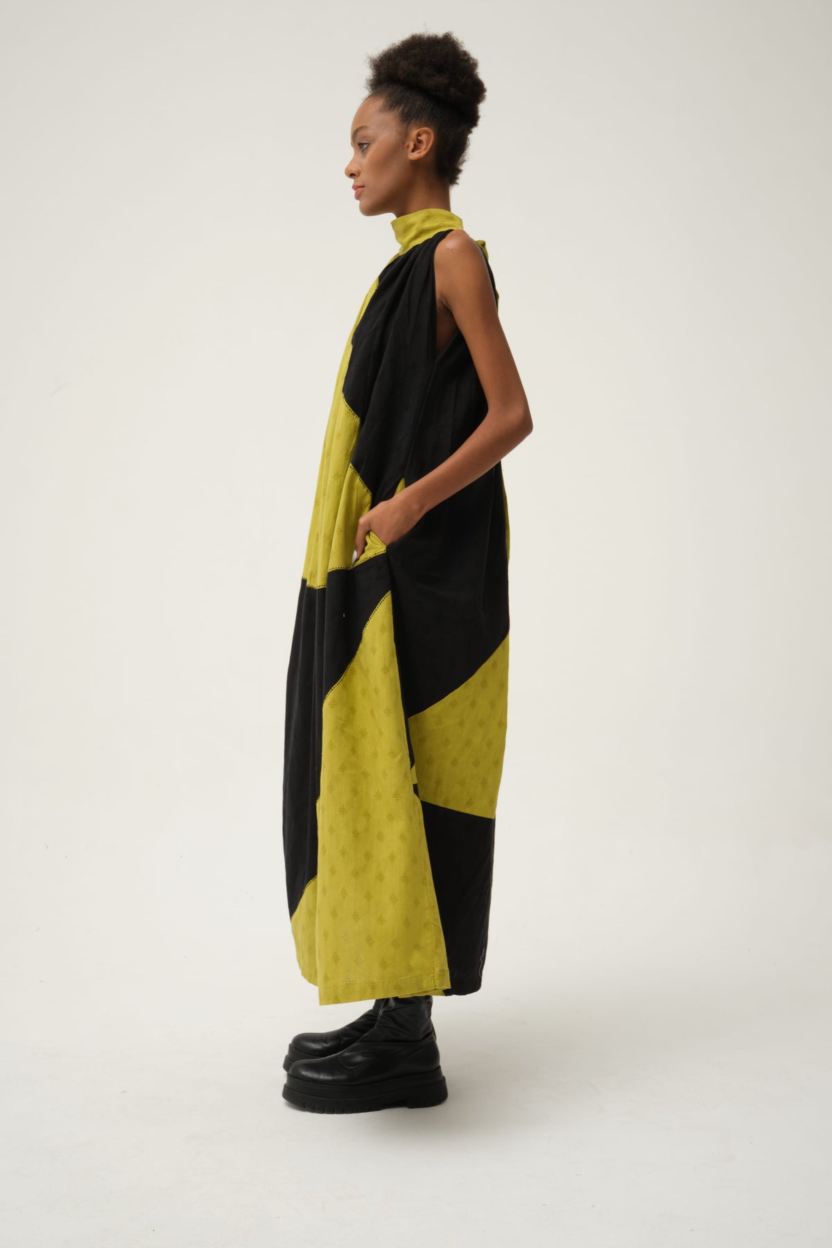 White Canvas Black Green Flintstone Dress in black handwoven dobby cotton with Kantha stitching, angled view on model