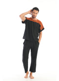 Black And Rust Colorblock Top Paired With Black Relaxed Pants In Handwoven Cotton By White Canvas – Image 1